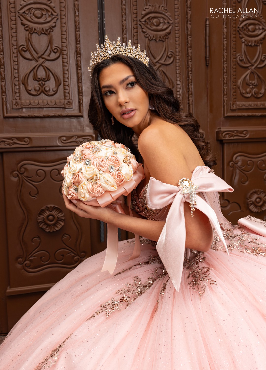 2.	Rachel Allan Style RQ3155 plunging ball gown with 3D floral appliqués, glitter tulle, and crystal satin in blush rose gold